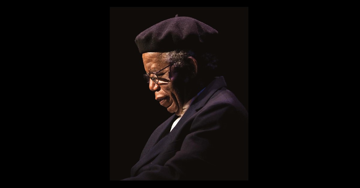 chinua achebe look down with background